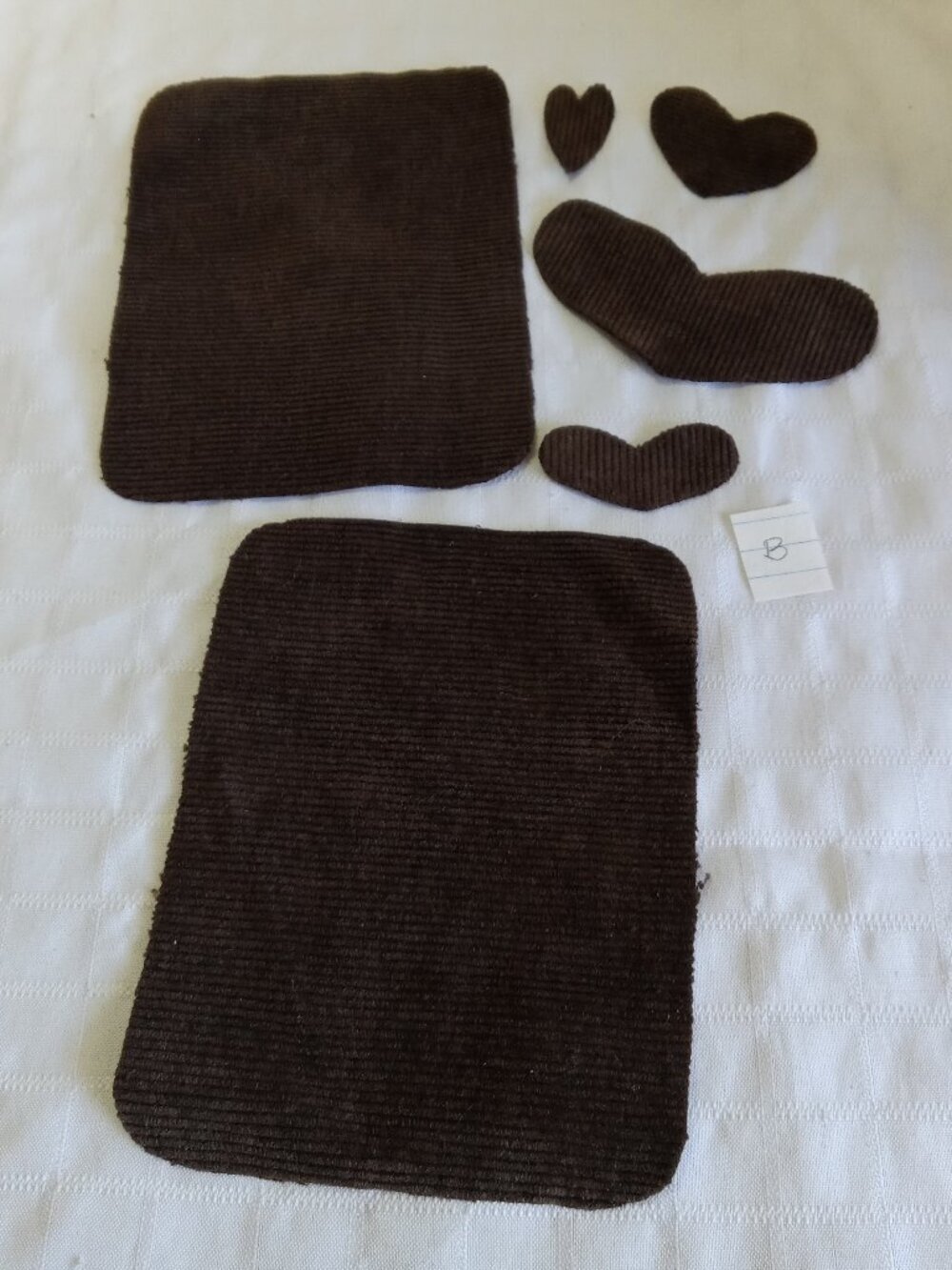 Two handmade elbow patches for sewing made of brown corduroy with hearts